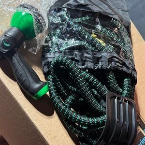 Green and Black Garden Hose with Spray Nozzle